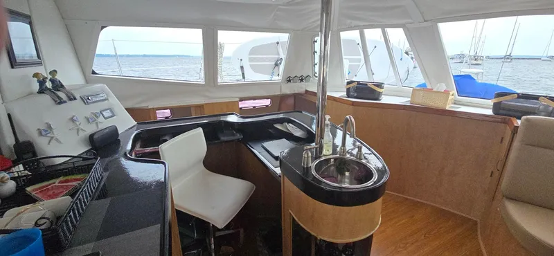 Bellagio Yacht Photos Pics Interior of 2013 Kelsall Suncat 40 yacht with modern kitchen and seating area.