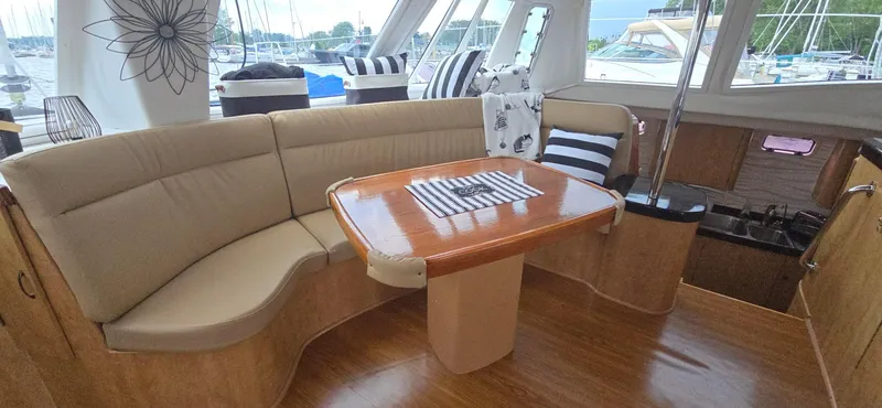 Bellagio Yacht Photos Pics Interior of 2013 Kelsall Suncat 40 yacht with elegant seating and wooden table.