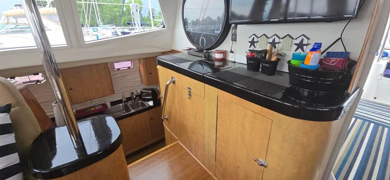 Bellagio Yacht Photos Pics Interior of 2013 Kelsall Suncat 40 yacht with wooden cabinetry and nautical decor.