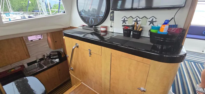 Bellagio Yacht Photos Pics Interior of 2013 Kelsall Suncat 40 yacht with wooden cabinetry and modern amenities.