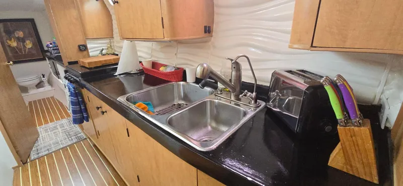 Bellagio Yacht Photos Pics Modern kitchen in 2013 Kelsall Suncat 40 yacht with dual sinks and wooden cabinetry.