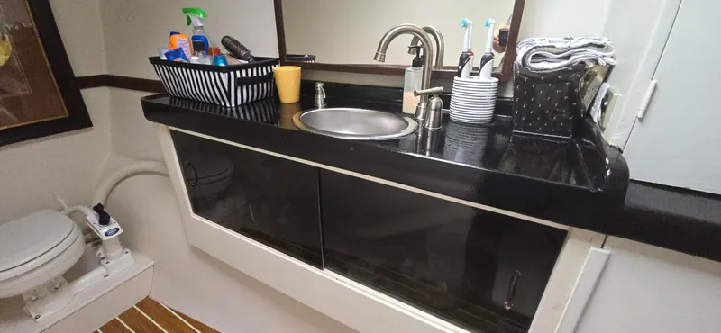 Bellagio Yacht Photos Pics Bathroom interior of 2013 Kelsall Suncat 40 with sink, toiletries, and toilet.