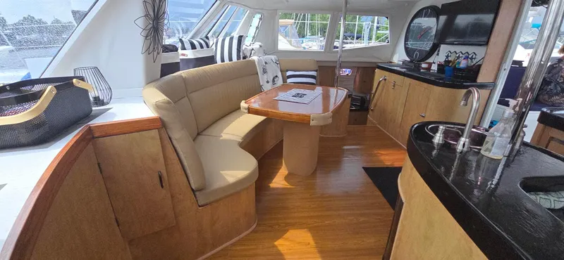 Bellagio Yacht Photos Pics Luxurious interior of 2013 Kelsall Suncat 40 yacht with modern furnishings and wood flooring.