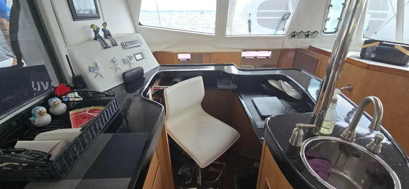 Bellagio Yacht Photos Pics Interior of 2013 Kelsall Suncat 40 yacht with modern kitchen and seating area.