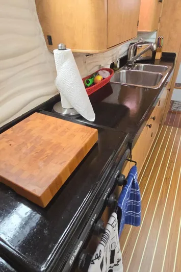 Bellagio Yacht Photos Pics Modern kitchen interior of 2013 Kelsall Suncat 40 yacht with sleek countertops and wooden cabinetry.