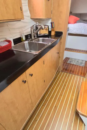 Bellagio Yacht Photos Pics 2013 Kelsall Suncat 40 yacht interior with modern kitchen and wood flooring.