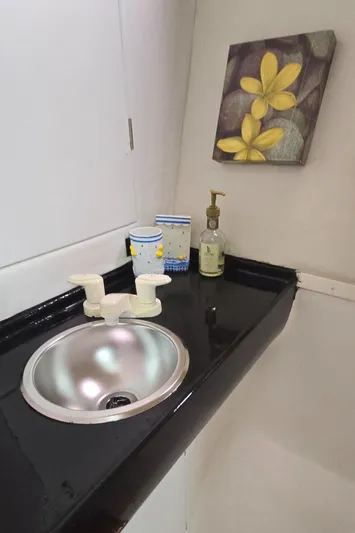 Bellagio Yacht Photos Pics 2013 Kelsall Suncat 40 bathroom with sink, floral decor, and toiletries.