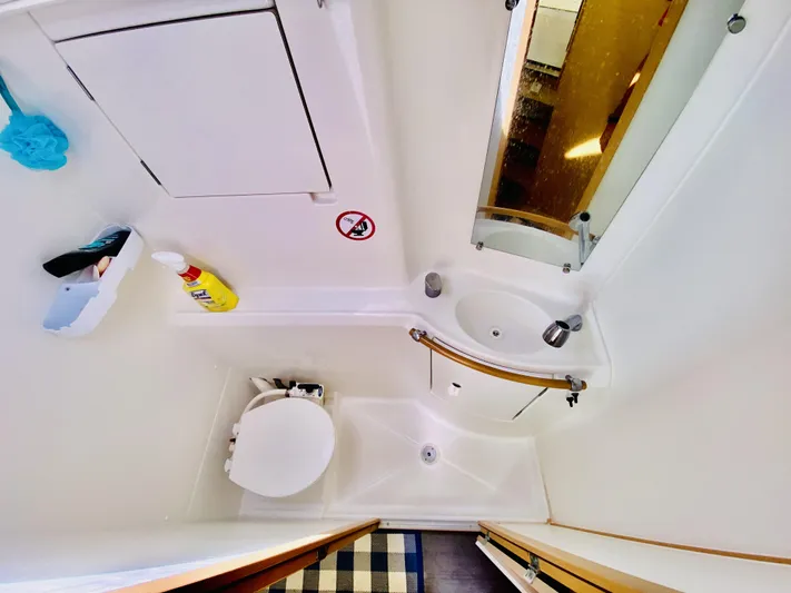 Finally Found Yacht Photos Pics 2014 Lagoon 380 S2 yacht bathroom with toilet, sink, and mirror.