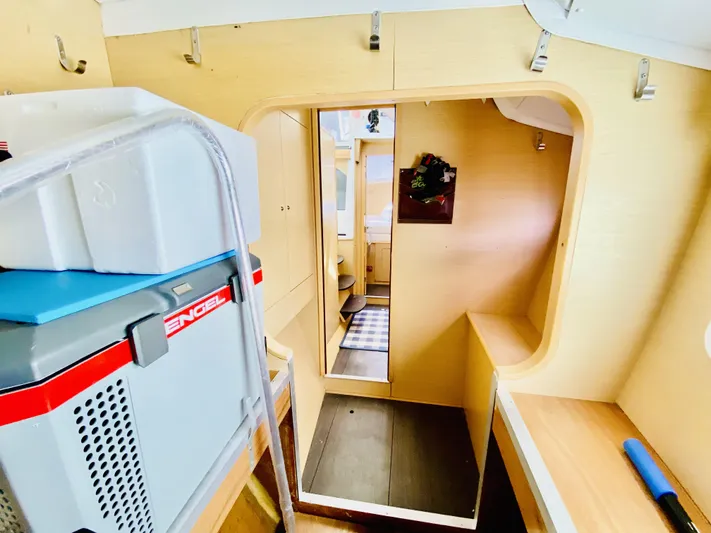 Finally Found Yacht Photos Pics Interior of a 2014 Lagoon 380 S2 catamaran, featuring compact storage and light wood finishes.