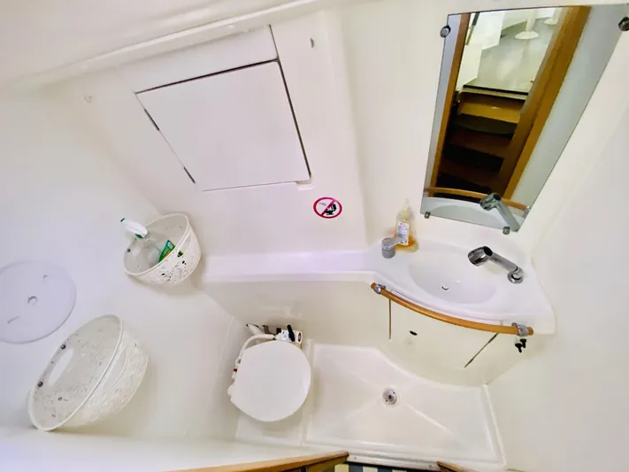Finally Found Yacht Photos Pics Compact bathroom in 2014 Lagoon 380 S2 catamaran with sink, toilet, and mirror.