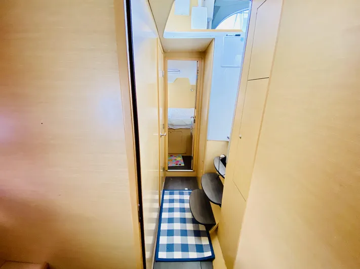 Finally Found Yacht Photos Pics Interior of 2014 Lagoon 380 S2 catamaran with wooden finish and checkered rug.