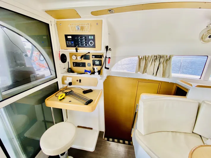 Finally Found Yacht Photos Pics Interior of 2014 Lagoon 380 S2 yacht with navigation controls and seating area.