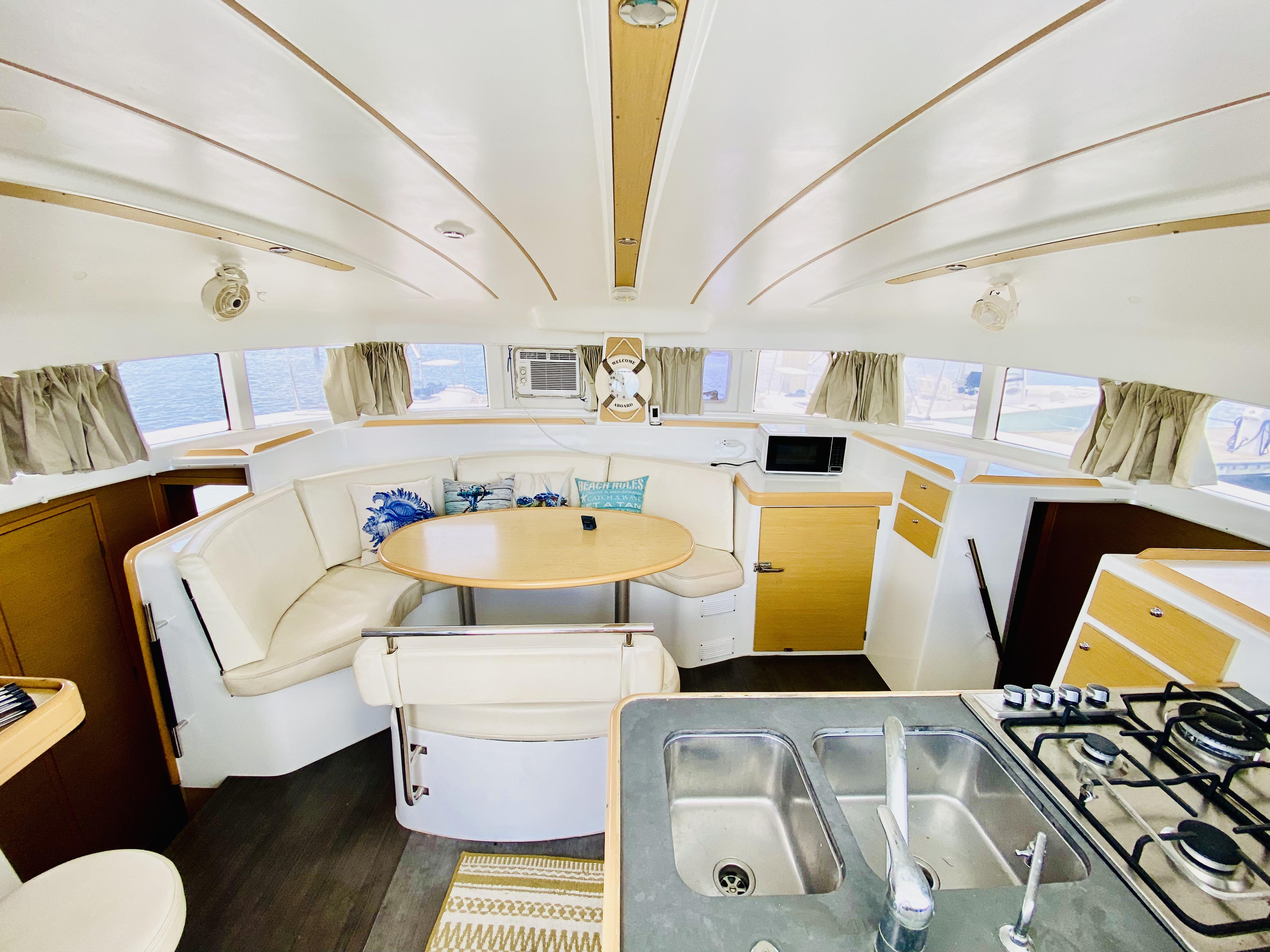 Interior of 2014 Lagoon 380 S2 catamaran with modern kitchen and dining area.