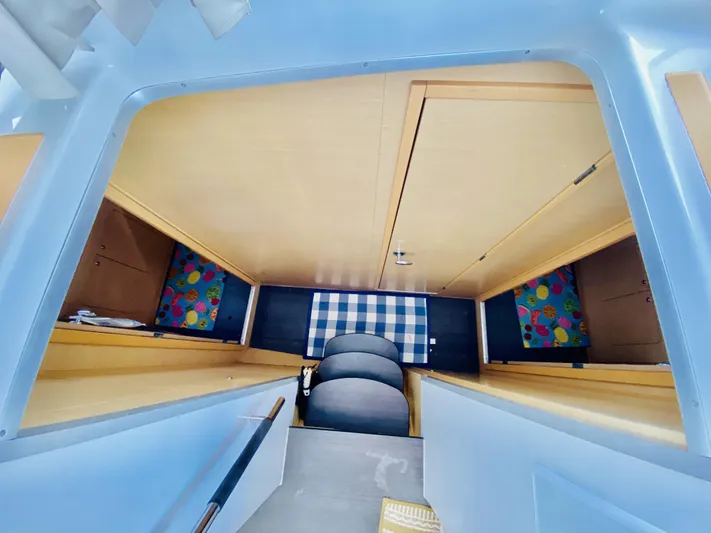 Finally Found Yacht Photos Pics Interior cabin of 2014 Lagoon 380 S2 catamaran with colorful decor and wooden finish.