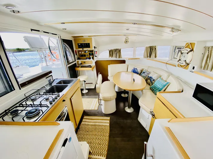 Finally Found Yacht Photos Pics Interior of 2014 Lagoon 380 S2 catamaran with kitchen and dining area.