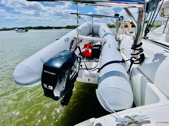 Finally Found Yacht Photos Pics Inflatable boat with Mercury 9.9 motor on Lagoon 380 S2, 2014 model, in shallow water.