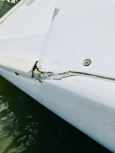 Finally Found Yacht Photos Pics Damaged hull of 2014 Lagoon 380 S2 catamaran with visible cracks and wear.