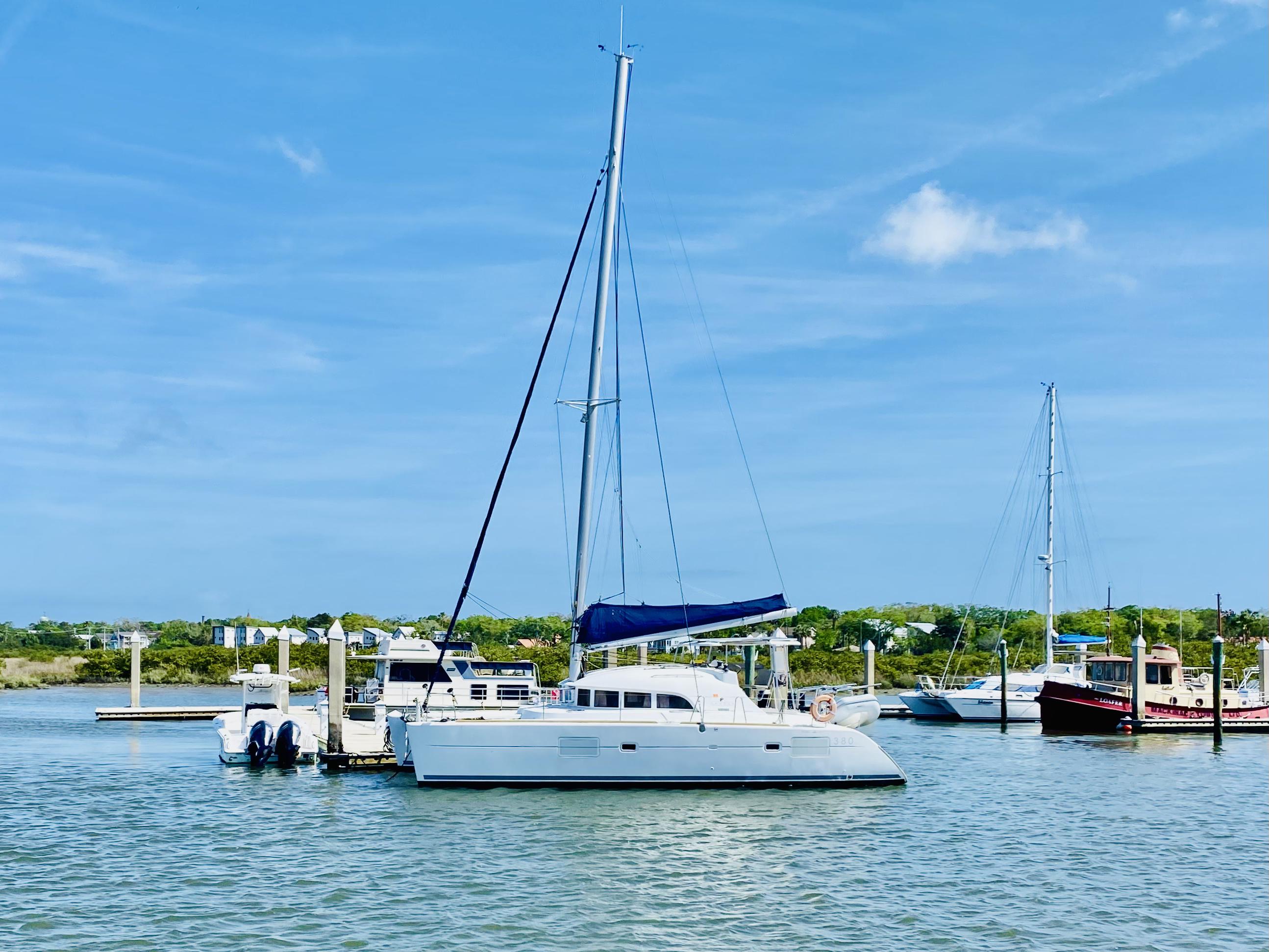 2014 Lagoon 380 S2 catamaran docked in a sunny marina.