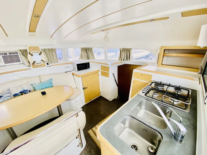 Finally Found Yacht Photos Pics Interior of 2014 Lagoon 380 S2 catamaran with kitchen and dining area.
