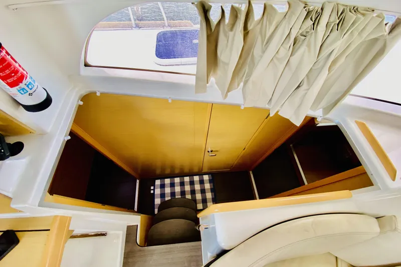 Finally Found Yacht Photos Pics Interior view of 2014 Lagoon 380 S2 yacht, featuring stairs and cozy seating area.