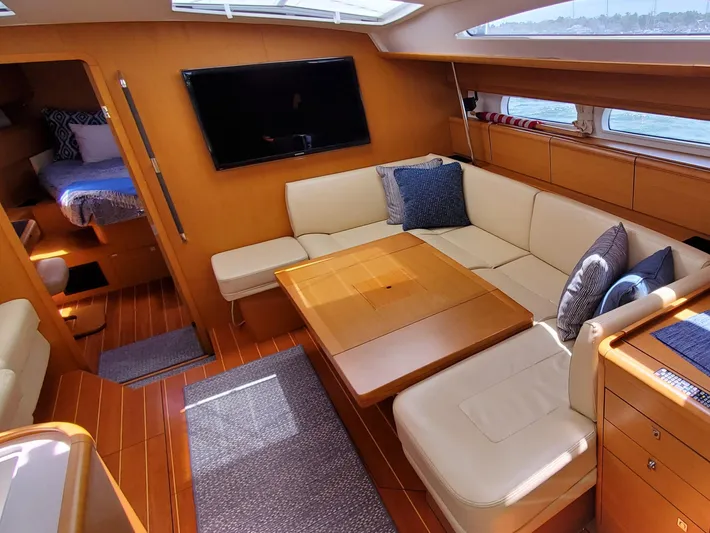 Spring Tide Yacht Photos Pics Luxurious interior of 2012 Jeanneau 53 sailboat with cozy seating and modern amenities.