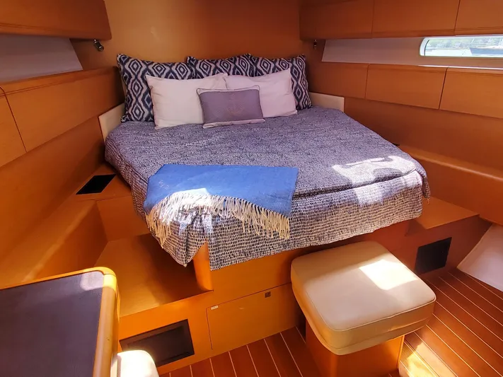 Spring Tide Yacht Photos Pics Luxurious cabin interior of 2012 Jeanneau 53 sailboat with cozy bed and seating.