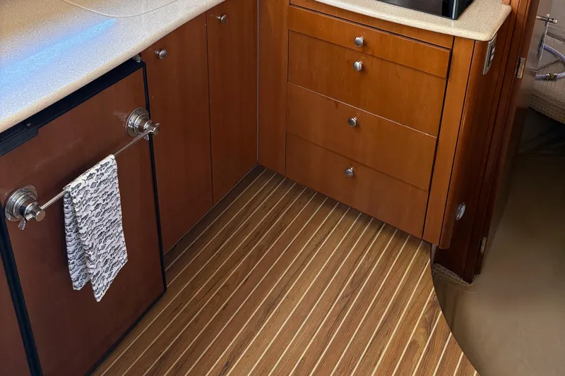  Yacht Photos Pics 2005 Meridian 368 Motoryacht interior with wooden cabinets and striped flooring.