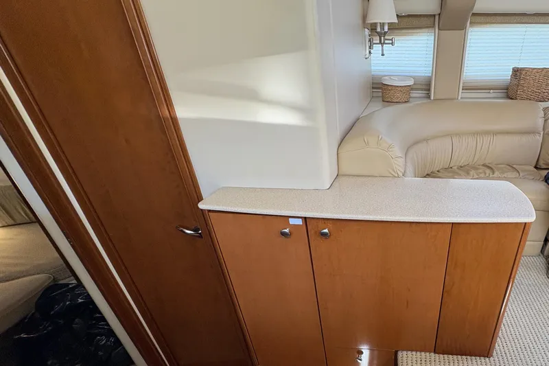  Yacht Photos Pics Interior of 2005 Meridian 368 Motoryacht with wooden cabinetry and beige seating.