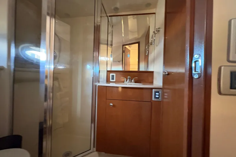  Yacht Photos Pics 2005 Meridian 368 Motoryacht bathroom with wood cabinetry and glass shower.