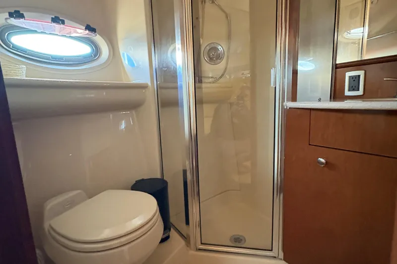  Yacht Photos Pics Bathroom interior of 2005 Meridian 368 Motoryacht with shower, toilet, and wooden cabinetry.