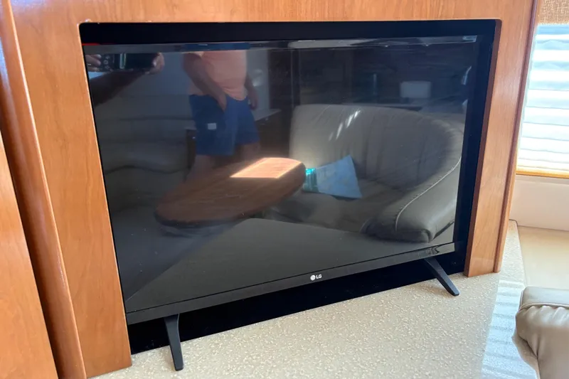  Yacht Photos Pics LG TV inside 2005 Meridian 368 Motoryacht, reflecting interior seating and table.
