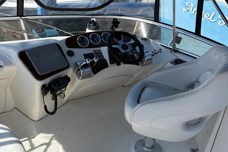  Yacht Photos Pics 2005 Meridian 368 Motoryacht helm with steering wheel, controls, and captain's chair.