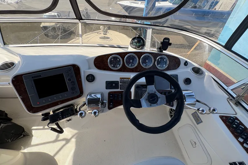  Yacht Photos Pics 2005 Meridian 368 Motoryacht helm with steering wheel, gauges, and navigation equipment.