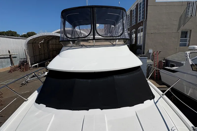  Yacht Photos Pics 2005 Meridian 368 Motoryacht docked, featuring sleek design and spacious upper deck.