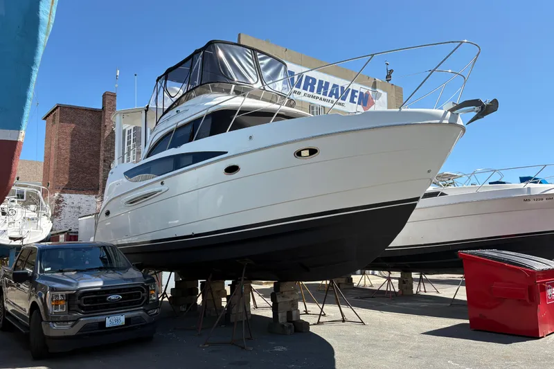  Yacht Photos Pics 2005 Meridian 368 Motoryacht on dry dock, with truck and buildings nearby.