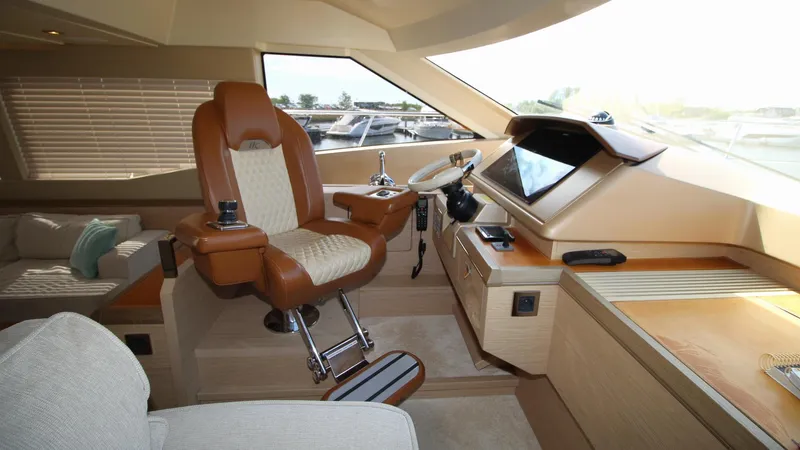  Yacht Photos Pics Luxurious helm station of 2015 Beneteau Monte Carlo 6 yacht with leather captain's chair.