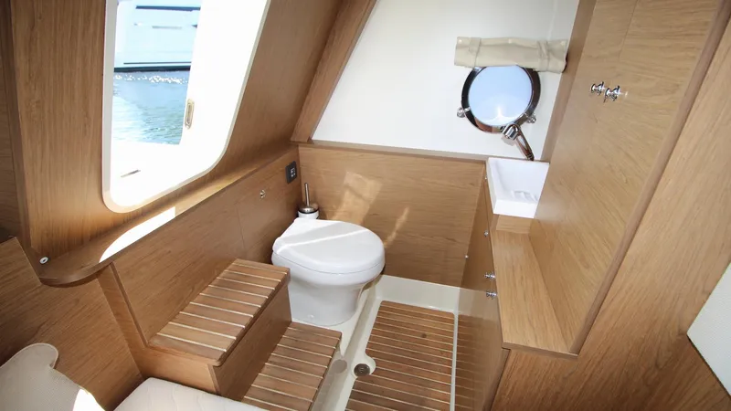  Yacht Photos Pics Luxurious bathroom interior of 2015 Beneteau Monte Carlo 6 yacht with wooden finishes.