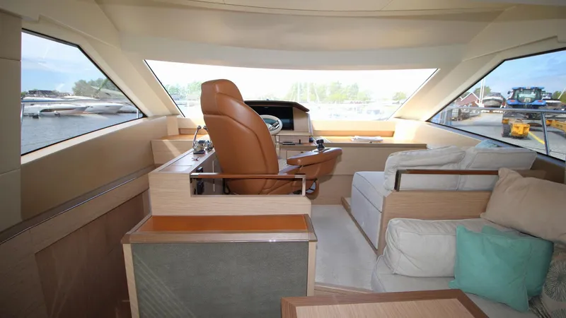  Yacht Photos Pics Interior of 2015 Beneteau Monte Carlo 6 yacht with helm and seating area.