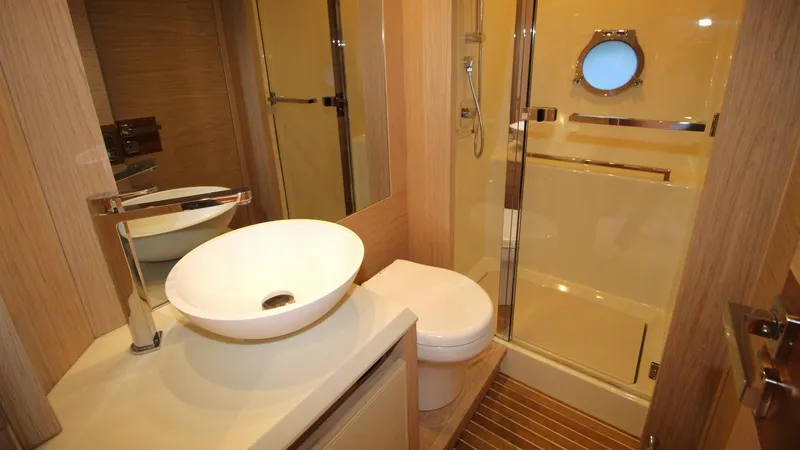  Yacht Photos Pics Luxurious bathroom in 2015 Beneteau Monte Carlo 6 yacht with modern fixtures and porthole window.