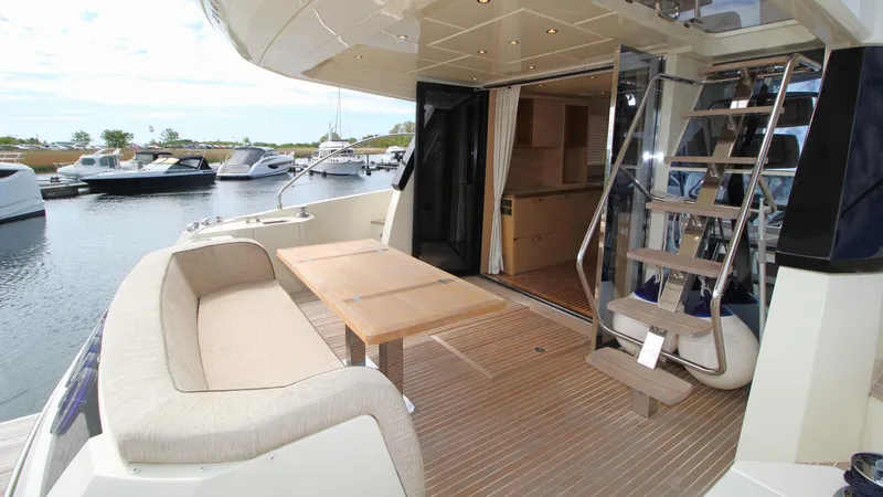  Yacht Photos Pics Luxurious 2015 Beneteau Monte Carlo 6 yacht interior with seating and staircase.