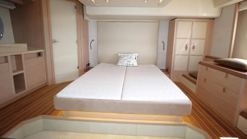  Yacht Photos Pics Luxurious bedroom interior of 2015 Beneteau Monte Carlo 6 yacht with modern furnishings.