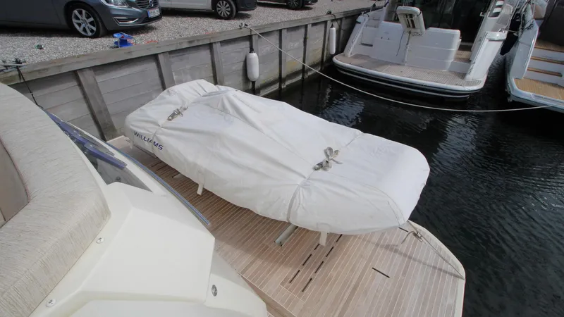  Yacht Photos Pics Covered tender on Beneteau Monte Carlo 6 yacht, 2015 model, docked at marina.