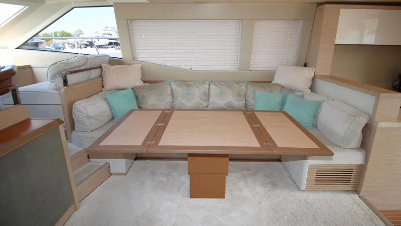  Yacht Photos Pics Luxurious interior of 2015 Beneteau Monte Carlo 6 yacht with cozy seating and elegant table.