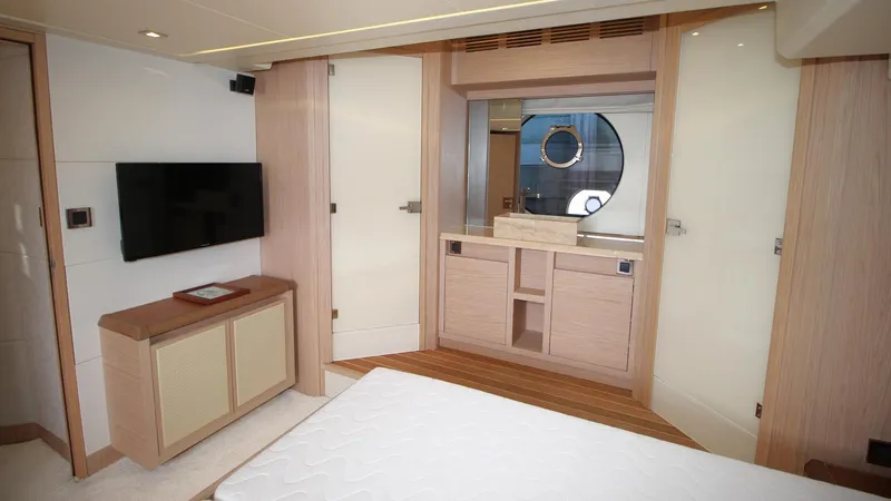  Yacht Photos Pics Luxurious interior of 2015 Beneteau Monte Carlo 6 yacht with modern furnishings and porthole window.