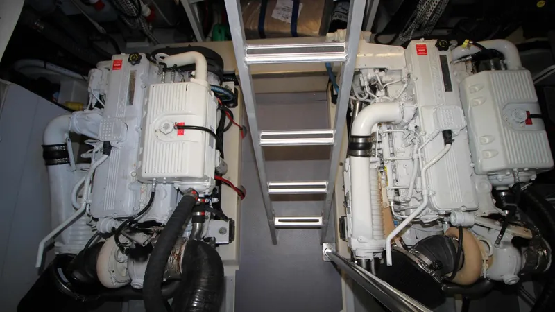  Yacht Photos Pics Engine room of 2015 Beneteau Monte Carlo 6 yacht, featuring dual engines and ladder access.