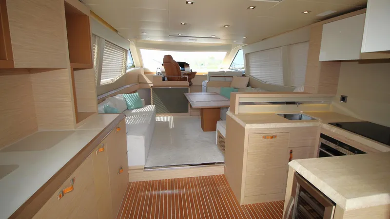  Yacht Photos Pics Luxurious interior of 2015 Beneteau Monte Carlo 6 yacht with modern kitchen and seating area.