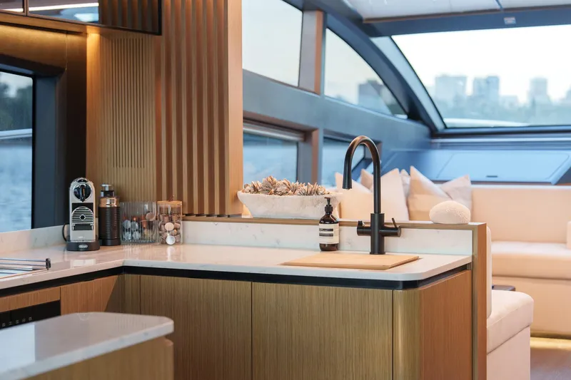 2023 Pearl 62 Luxury Yacht Yacht Photos Pics Luxurious interior of 2023 Pearl 62 yacht with modern kitchen and seating area.