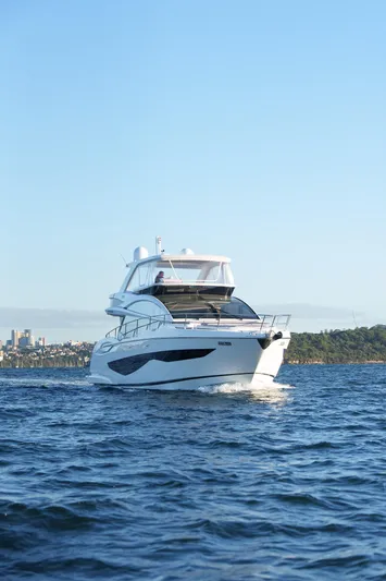 2023 Pearl 62 Luxury Yacht Yacht Photos Pics 2023 Pearl 62 yacht cruising on open water under clear blue sky.