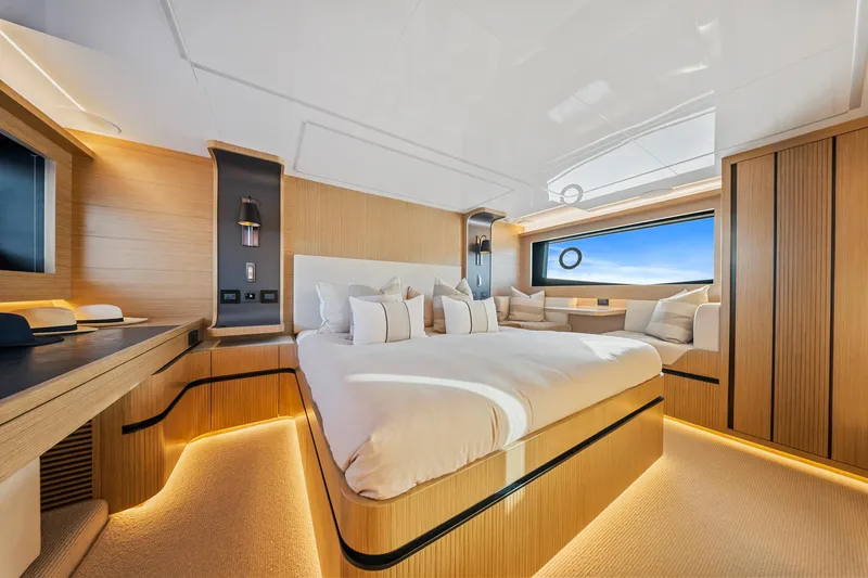 2023 Pearl 62 Luxury Yacht Yacht Photos Pics Luxurious bedroom interior on 2023 Pearl 62 yacht, featuring modern design and ambient lighting.