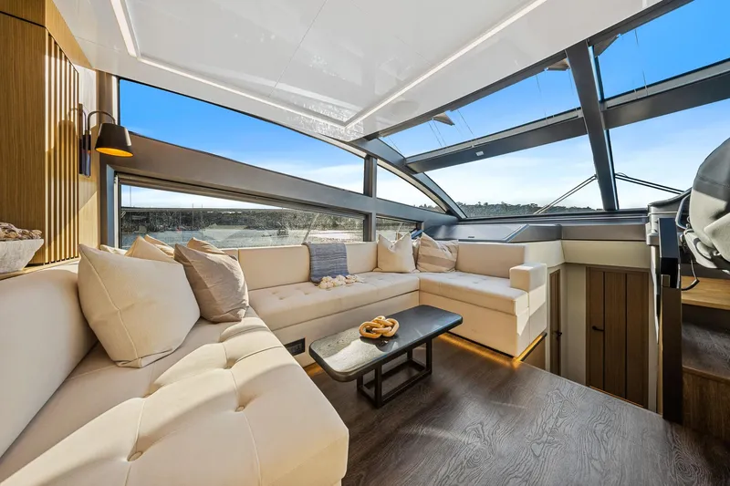 2023 Pearl 62 Luxury Yacht Yacht Photos Pics Luxurious interior of 2023 Pearl 62 yacht with elegant seating and panoramic windows.